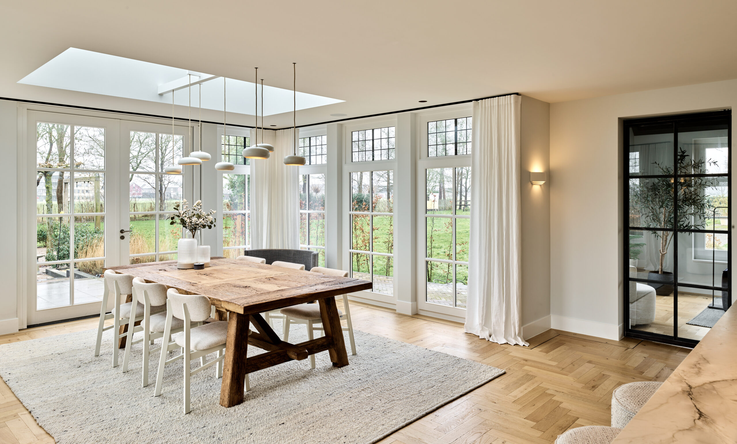 Bright, modern dining room with greenery